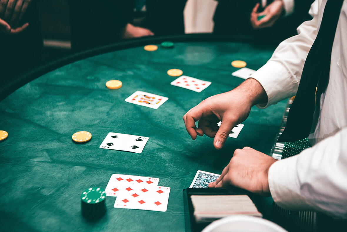 Dealer handing out cards on a green table